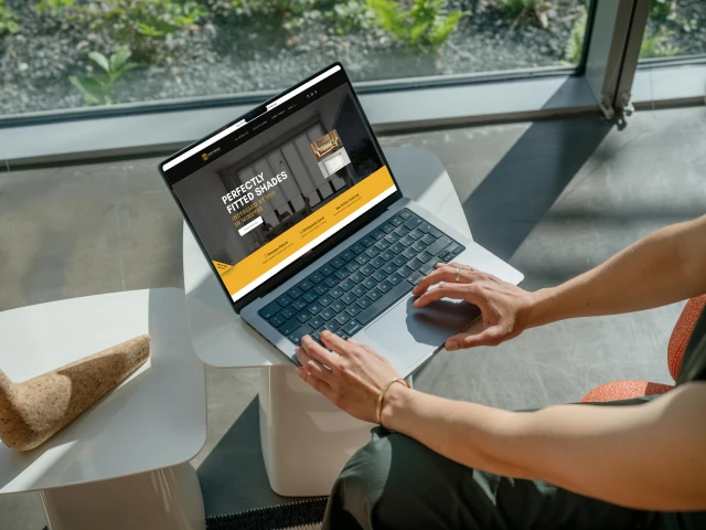 Dollar Blinds website shown on a laptop