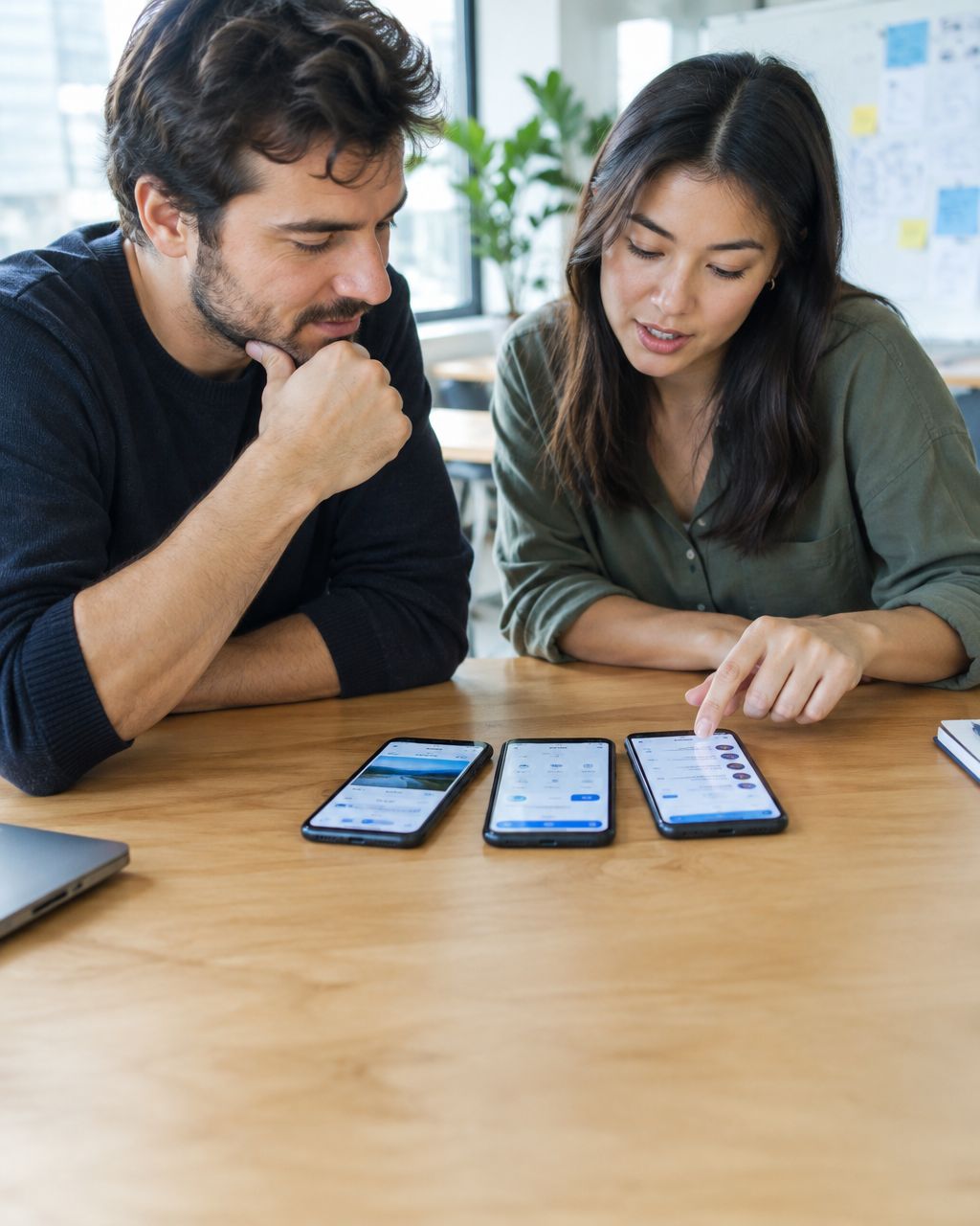 Founder and product manager reviewing mobile app prototypes on smartphones