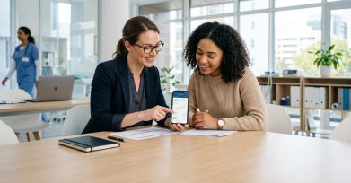 Two startup founders reviewing a mobile health app in a clinic office