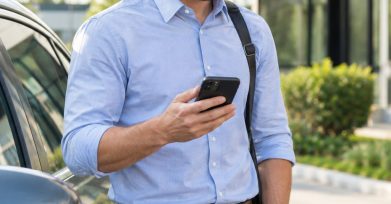 Field sales representative checking a Salesforce-connected mobile app outside a client site